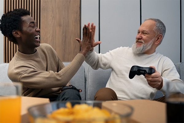 Elderly person and caregiver playing cards together