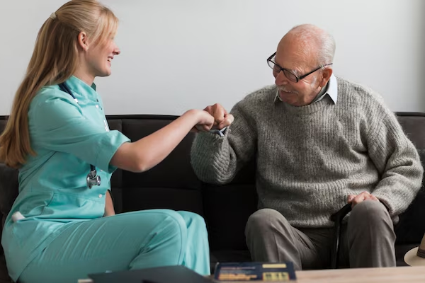 Caregiver assisting elderly person on a walk in the park