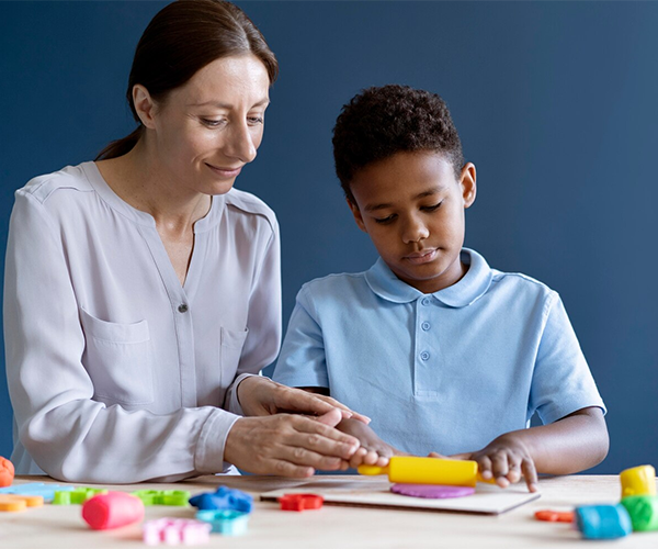 Caregiver assisting elderly person on a walk in the park